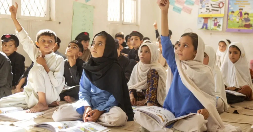 Children studying in village classroom supporting rural Pakistan healthcare and education